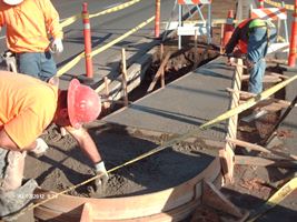 Construction workers pouring cement