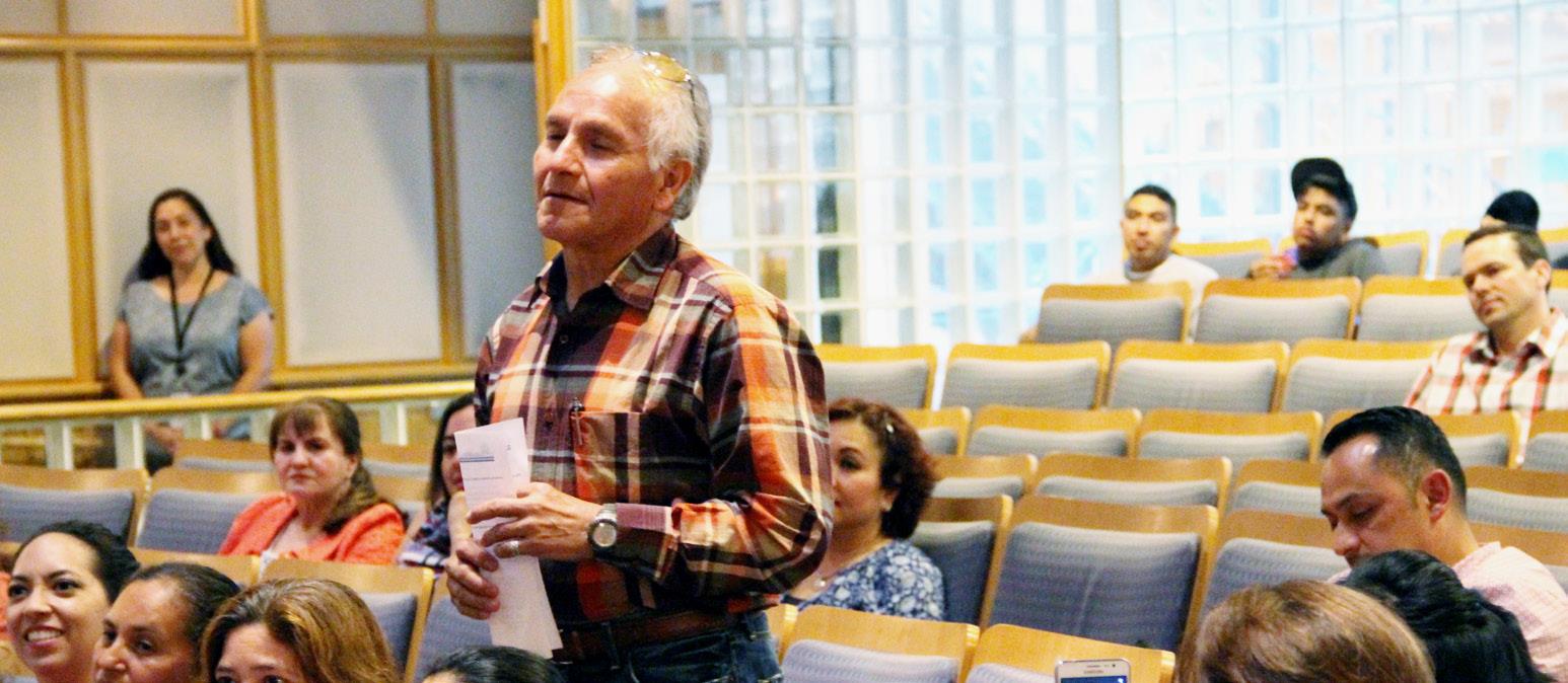 Person standing and speaking at a meeting in a room